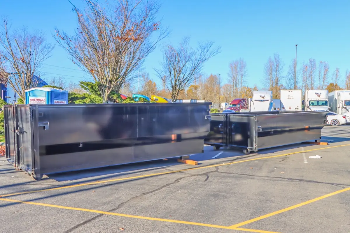 Professional dumpster rental service with roll-off container on residential driveway in East San Gabriel